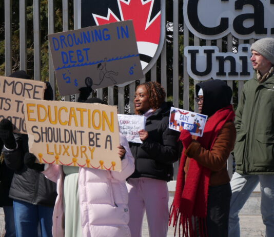 In photos: Walkout for OSAP slows traffic on Bronson Avenue People holding a sign and protesting OSAP changes