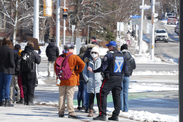 Ottawa police officer talking to two attendees