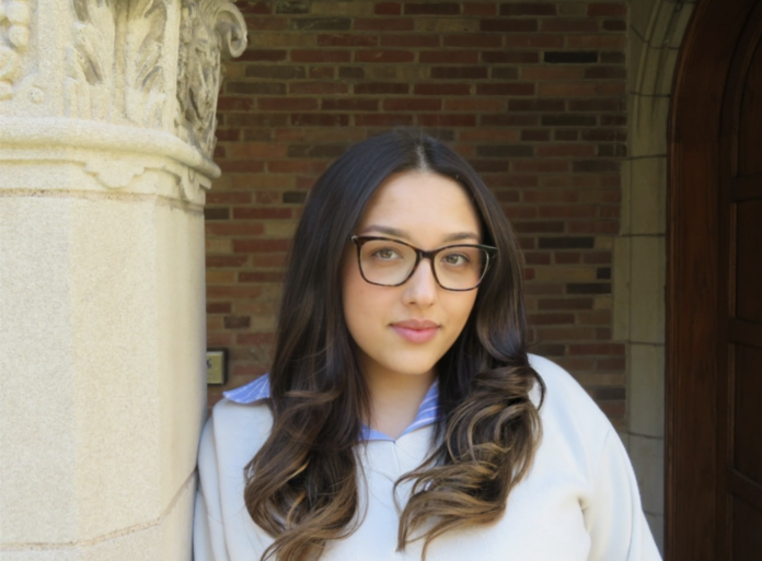 A woman pictured in front of a building