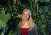 Carleton students are turning away from their American graduate studies dreams A woman is standing in front of the green plant wall.