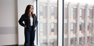 How volunteering builds joy and connection in racialized Canadian communities A standing woman looks out of a window.