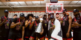 NATIONAL CHAMPIONS: Aubrey Dorey-Havens lifts the Ravens to their 18th U SPORTS national title Trophy photo