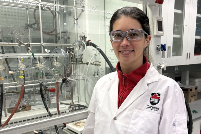 unnamed (22) Kate Marczenko wearing a white lab coat in a lab.