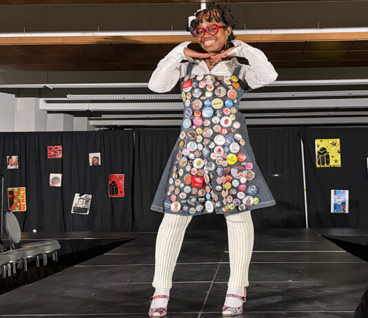 In photos: Carleton fashion show brings ‘backstage magic’ to highlight legacy of Black creatives A woman stands on a runway wearing a dress with patches on it