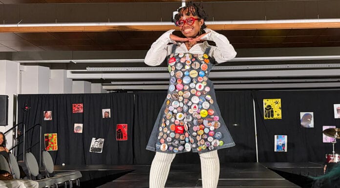 In photos: Carleton fashion show brings ‘backstage magic’ to highlight legacy of Black creatives A woman stands on a runway wearing a dress with patches on it