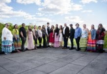 ‘We quickly became a family’: Carleton’s Indigenous journalism certificate wraps up its first year People line up outdoors on a concrete patio at Carleton University. There's a bright blue sky with the people standing and smiling across the frame.