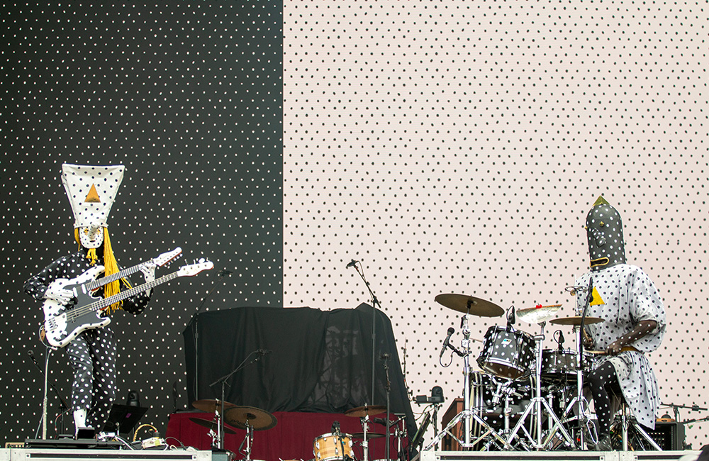 Polka dot costumed drummer and guitarist play on stage
