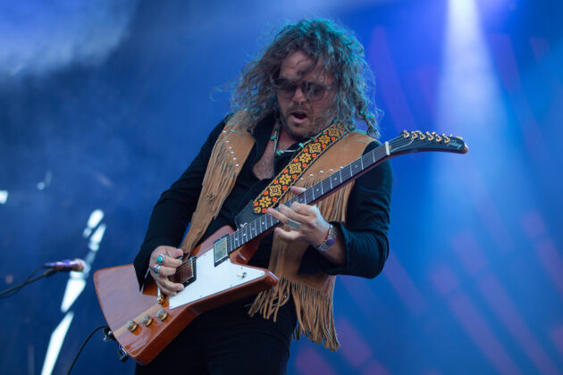 Man plays electric guitar
