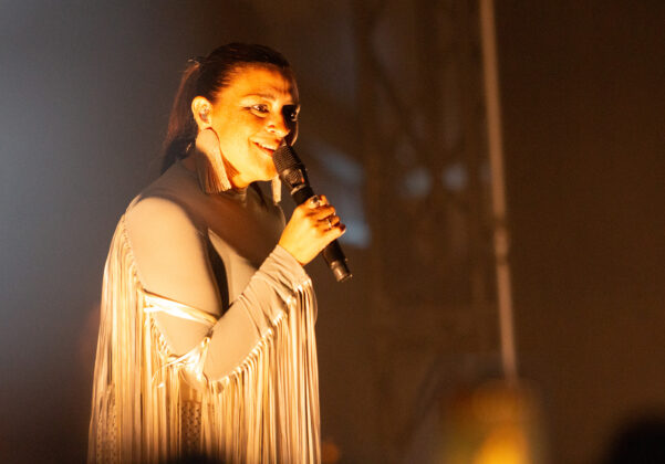 Woman holds mic smiling