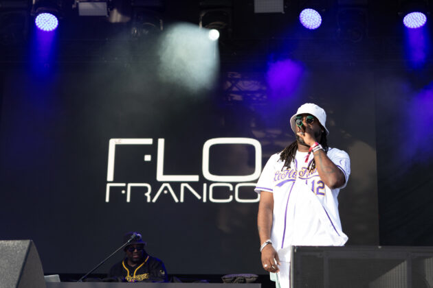 Man in bucket hat sings on stage