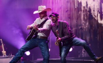 Bluesfest Day 1 review: Cody Johnson delivers fireworks and musical insights under cloudy skies Guitarists perform beside one another on stage