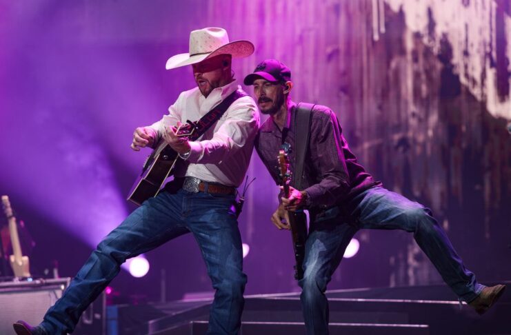 Bluesfest Day 1 review: Cody Johnson delivers fireworks and musical insights under cloudy skies Guitarists perform beside one another on stage