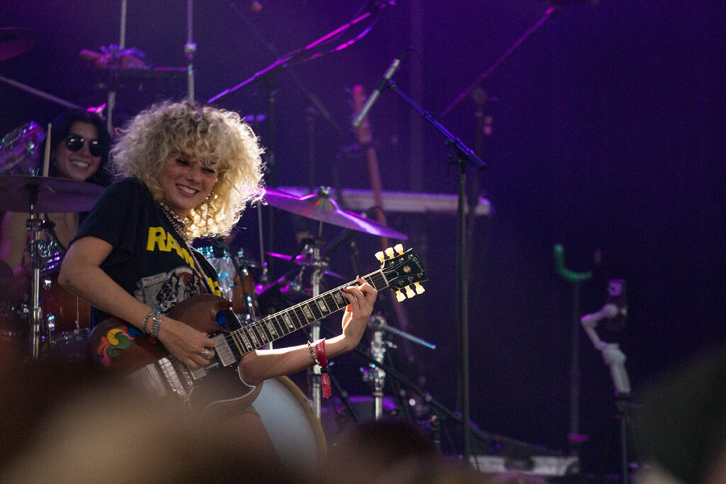 Girl grins playing guitar