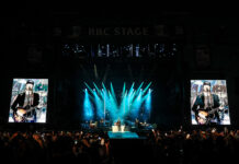 Bluesfest Day 4 review: The Lumineers close out a genre-spanning Sunday to a jam-packed audience Massive crowd at LeBreton flats in front of RBC Stage with bright screens and lights illuminating band on stage