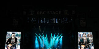 Bluesfest Day 4 review: The Lumineers close out a genre-spanning Sunday to a jam-packed audience Massive crowd at LeBreton flats in front of RBC Stage with bright screens and lights illuminating band on stage