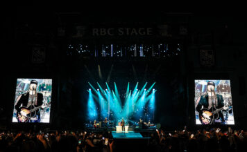 Bluesfest Day 4 review: The Lumineers close out a genre-spanning Sunday to a jam-packed audience Massive crowd at LeBreton flats in front of RBC Stage with bright screens and lights illuminating band on stage