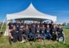 Carleton’s Blackbird UAV design team stands out at national competition Blackbird team members stand in front of a white tent.