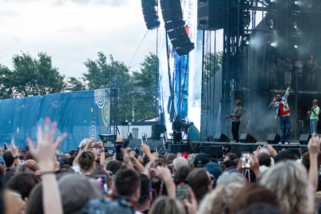 Crowd raises hands in the air for singer on stage