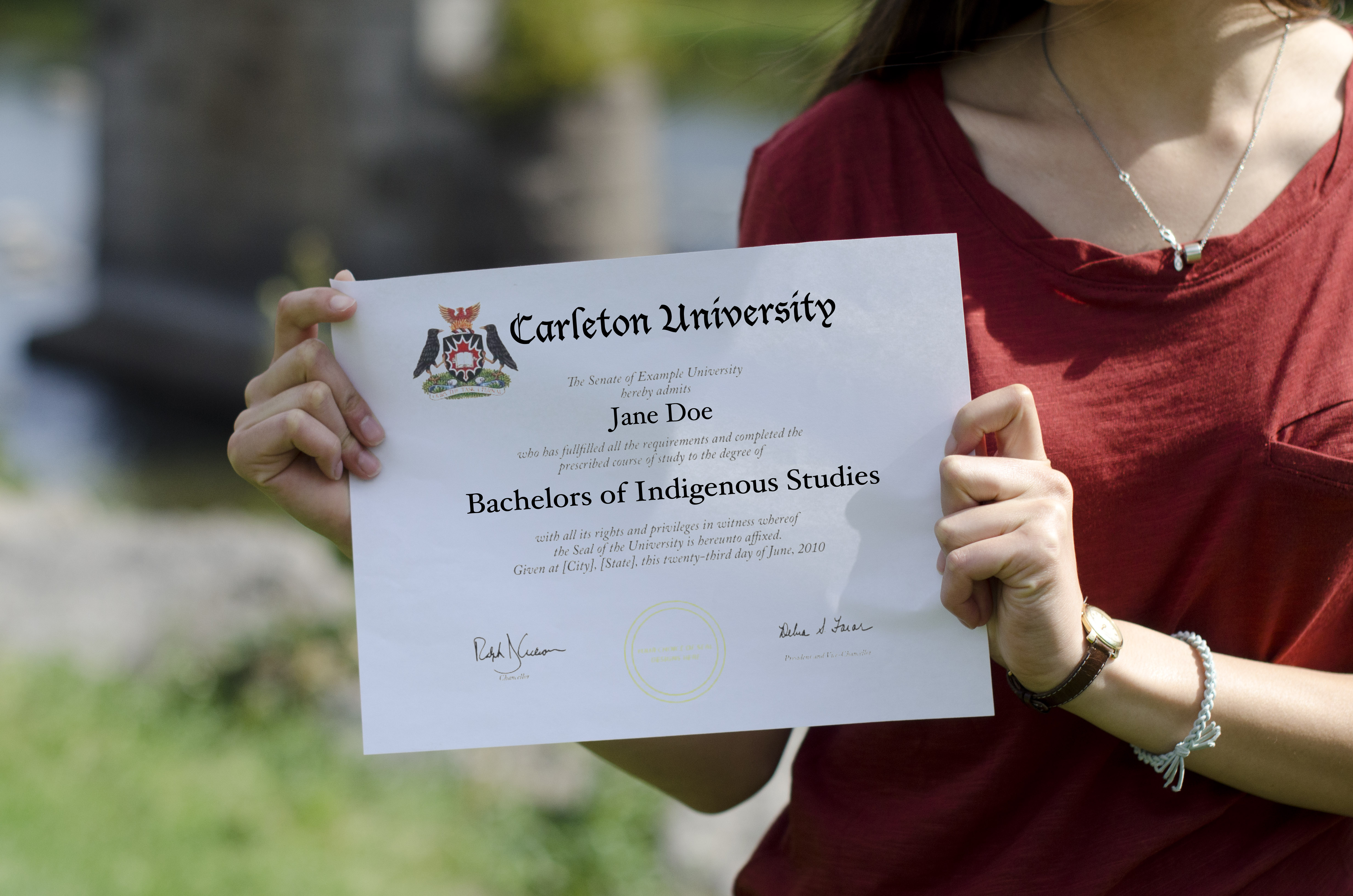 nindigenousstudies8_trevorswann_web A person holds an Indigenous studies graduating certificate.